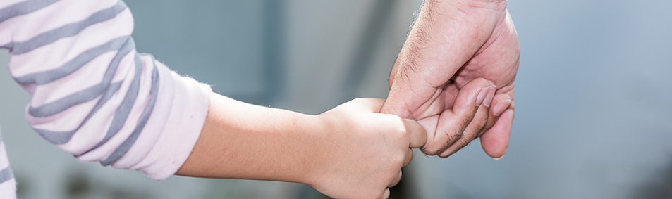 fostering image of guardian and child holding hands